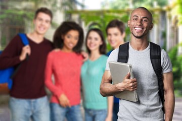 Smiling young college student with laptop