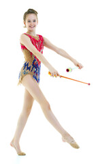 A girl gymnast performs exercises with a mace.