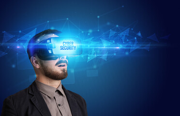 Businessman looking through Virtual Reality glasses with CYBER SECURITY inscription, cyber security concept