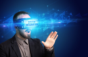 Businessman looking through Virtual Reality glasses with SYSTEM INTEGRATION inscription, cyber security concept