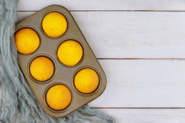 Overhead view of plain homemade cupcakes in baking tray.