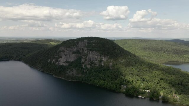 Lush Green Forest By The Mount Pinacle By The Calm Lake Lyster In Coaticook, Quebec Canada.  - aerial drone