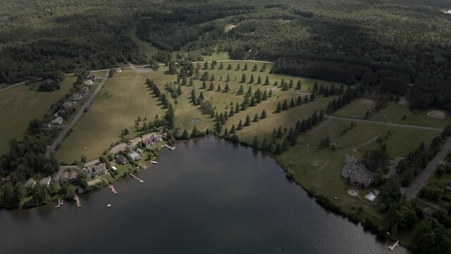 Stunning Landscape Of Small Village By The Calm Lake Near The Mount Pinacle In Coaticook, Quebec, Canada.  - aerial drone
