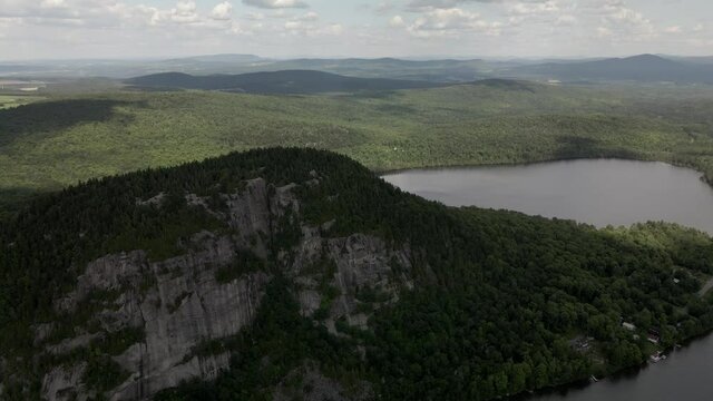 Landscape Of Lush Green Coastal Mountain Range Of Mount Pinacle And Calm Lake In Coaticook, Quebec Canada.  - aerial drone