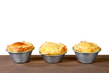 baked pie stuffed with chicken, shrimp, meat on the table, isolated on white background. typical Brazilian food empadinha