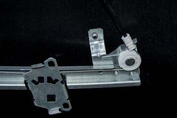 The mechanism of the electric window lifter of a car close up