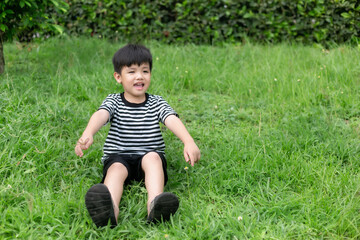 Portrait of a happy little boy in the park