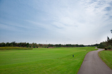 Curvy pathway between meadows in golf course