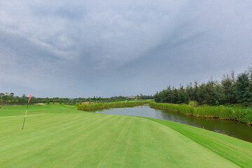 Empty golf course with lake view on a gloomy day