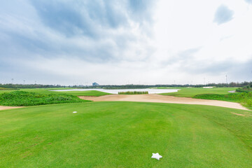 lake view golf course with bunkers clouds on a gloomy day