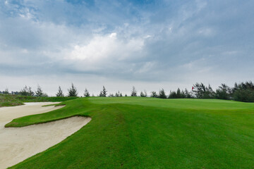 Fototapeta na wymiar golf course and bunkers with clouds on a gloomy day