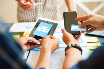 Web designers meeting to discuss designing mobile applications.