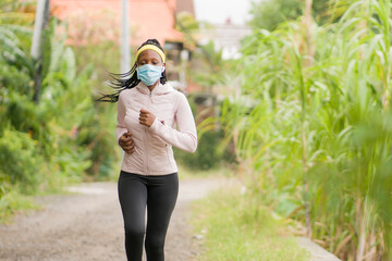 post quarantine runner girl enjoying outdoors workout - young attractive and fit black African...