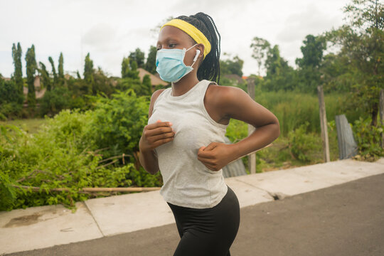 Post Quarantine Runner Girl Enjoying Outdoors Workout - Young Attractive And Fit Black African American Woman Running Wearing Face Mask In New Normal Sport Practice