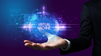 Man hand holding VIRTUAL MACHINE inscription, technology concept