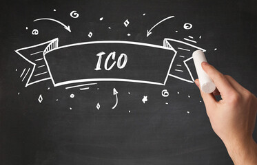 Hand drawing ICO abbreviation with white chalk on blackboard