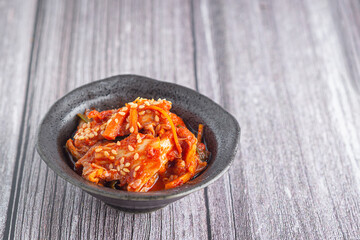 Traditional Korean dishes or Kimchi in a bowl on wooden table