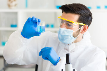 Scientist is mixing chemical reagents in the laboratory.