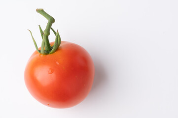 Fresh tomatoes on a green stem on white