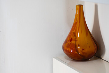 Brown vase on the table. Bright and decorative made of glass. Close up.