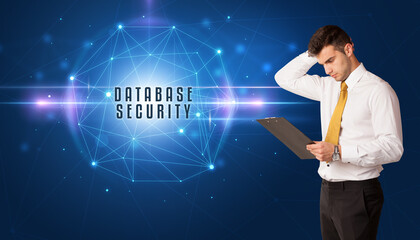 Businessman thinking about security solutions with DATABASE SECURITY inscription