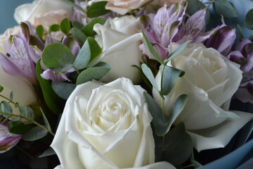 
flower bouquet in cold colors with a white rose accent
