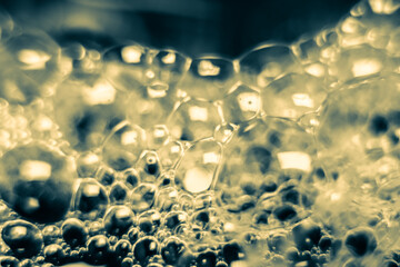 bubbles soap on water surface, shine with a bright, shimmering reflected light.