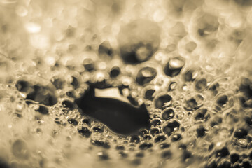 bubbles soap on water surface, shine with a bright, shimmering reflected light.