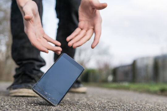 Low Section Of Man Dropped Smart Phone On Road