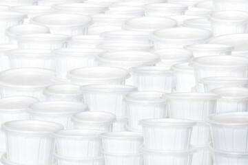 White plastic small containers for food delivery. Empty food plastic containers with its lid on it.