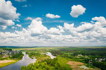 Nature with river forest clouds on a blue sky ecological landscape beautiful summer day. Aerial view
