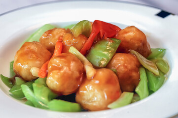 Stir fried shrimp balls in a white dish