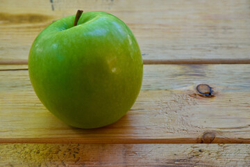 Green apple place on wooden table