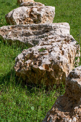 Fototapeta na wymiar jurassic limestone boulders on a meadow in sunlight