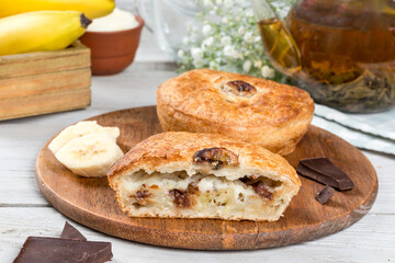 Pie with banana and chocolate cut in half
