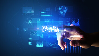 Hand touching SOFTWARE INNOVATION inscription, new business technology concept