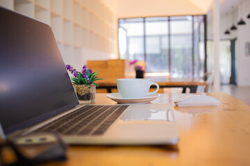 notebook was placed on a table by the window for doing business online at home during the outbreak of the Covid outbreak.