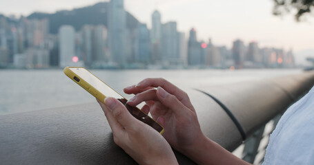 Woman use of smart phone in city