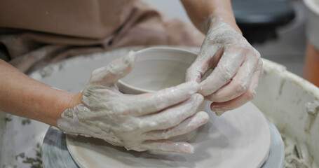 Potter making ceramic pot on the pottery wheel
