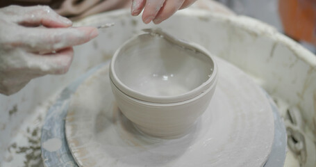 Potter making ceramic pot on the pottery wheel