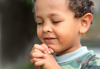 boy praying with hands together stock photo © herlanzer