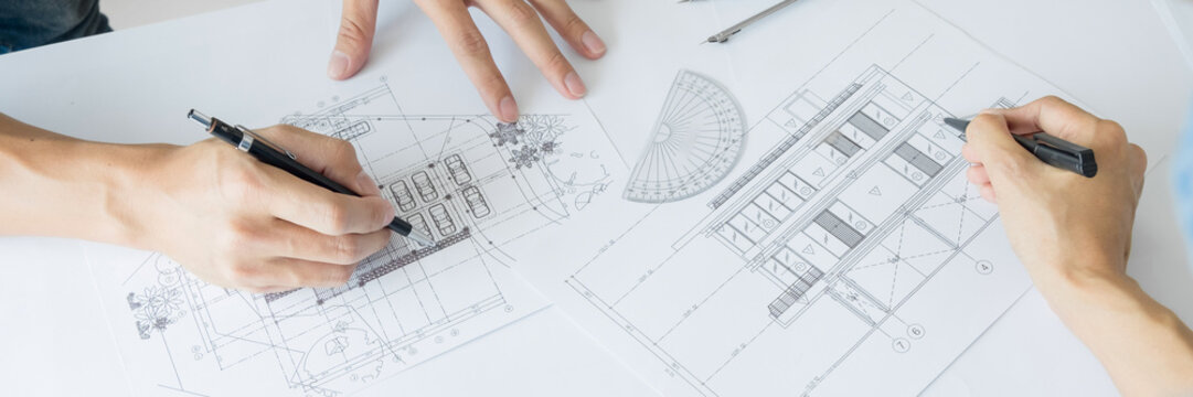 Engineer of architect starting draw a house blueprint on the desk in the office at construction working site