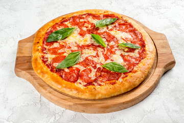 Pizza with sausage and herbs on a wooden board