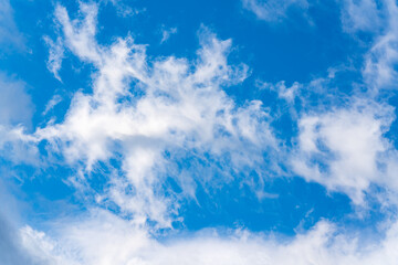 Soft white clouds against blue sky background. Motion blur sky cloudscape
