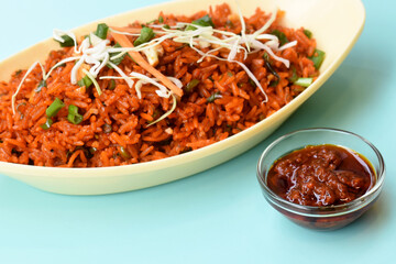 Schezwan fried rice with schezwan sauce, Chinese fried rice,garnished with spring onion and cabbage.indo chinese cuisine dishes.selective focus