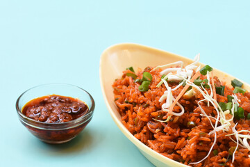 Schezwan fried rice with schezwan sauce, Chinese fried rice,garnished with spring onion and cabbage.indo chinese cuisine dishes.selective focus