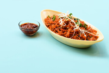 Schezwan fried rice with schezwan sauce, Chinese fried rice,garnished with spring onion and cabbage.indo chinese cuisine dishes.selective focus