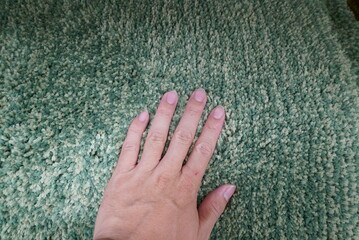 Hand to check the softness of the cushion