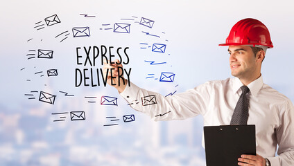 Handsome businessman with helmet drawing EXPRESS DELIVERY inscription, contruction sale concept