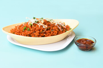 Schezwan fried rice with schezwan sauce, Chinese fried rice,garnished with spring onion and cabbage.indo chinese cuisine dishes.selective focus